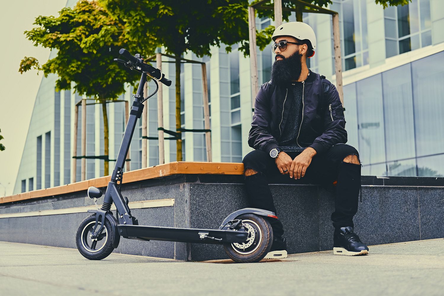 Scooter_man_helmet_sitting_outdoors_day