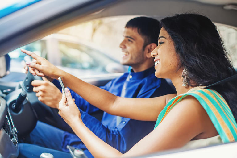 Couple in car with mobile phone