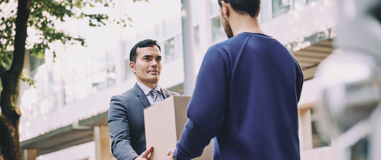 A delivery driver handing a package to a customer.