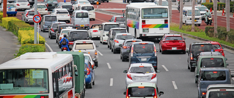 A photo of cars and buses in heavy traffic .