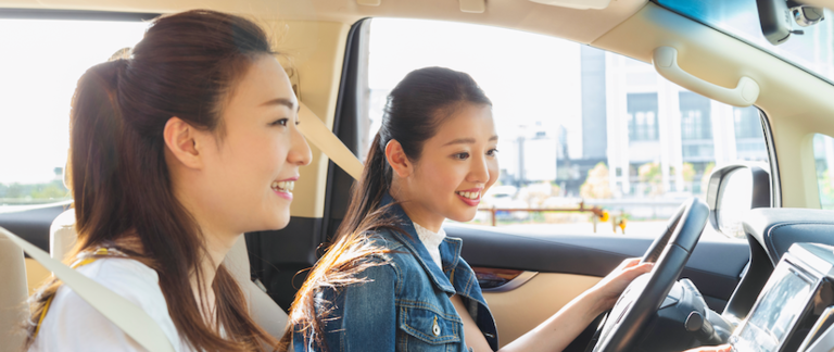 Two friends going for a nice drive in their car.