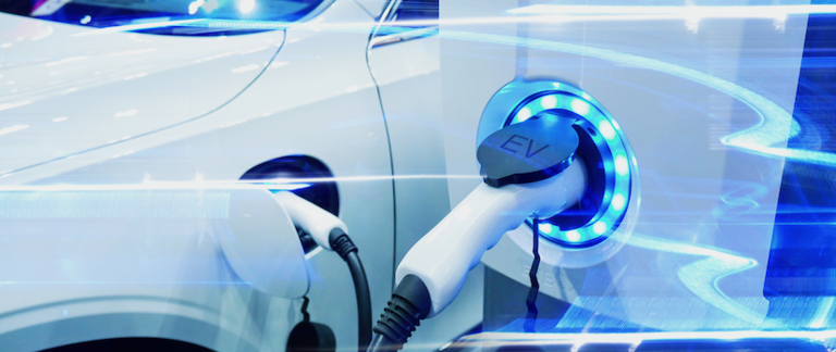 A futuristic close-up of an electric vehicle charging at a charge point.