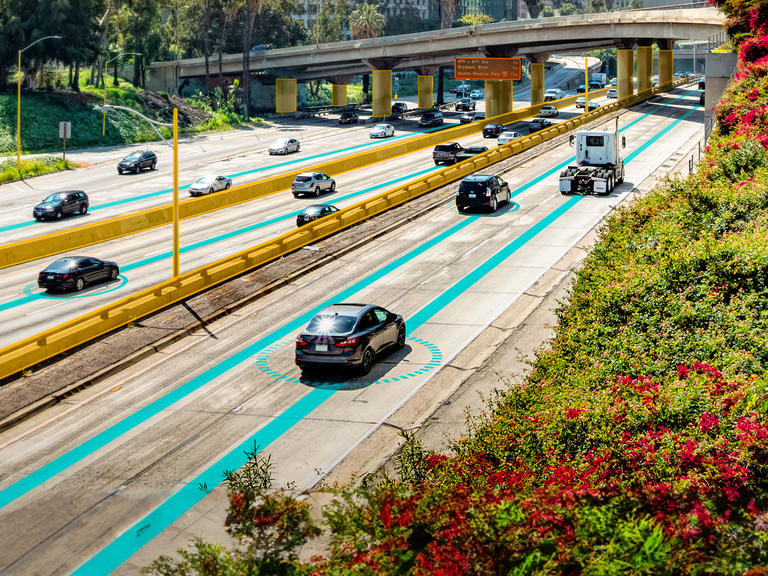 A view of cars driving on a highway, with "connected cars" graphic overlay.