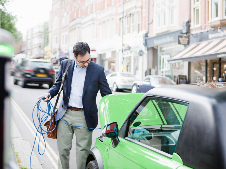 An electric vehicle charging at an urban charge point.