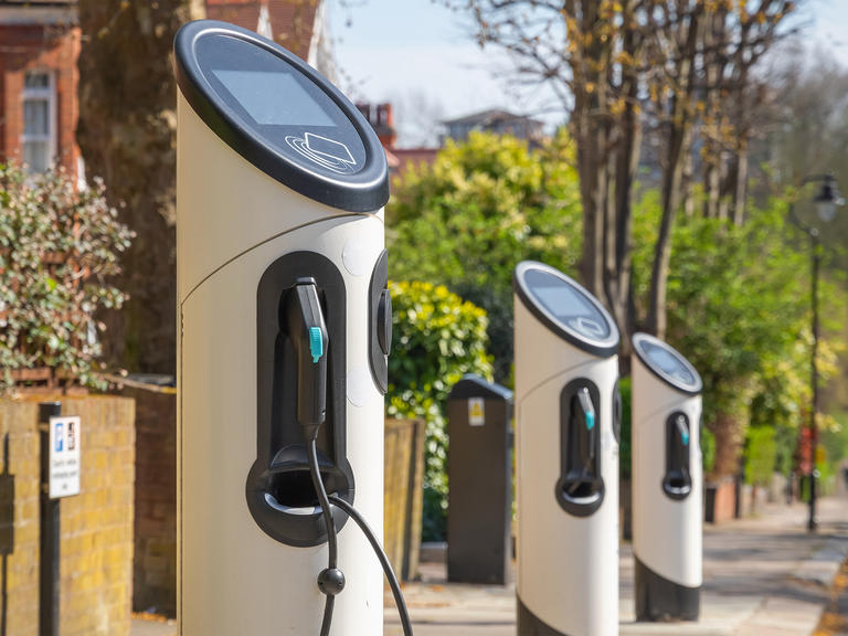 A row of electric charging stations on a street.