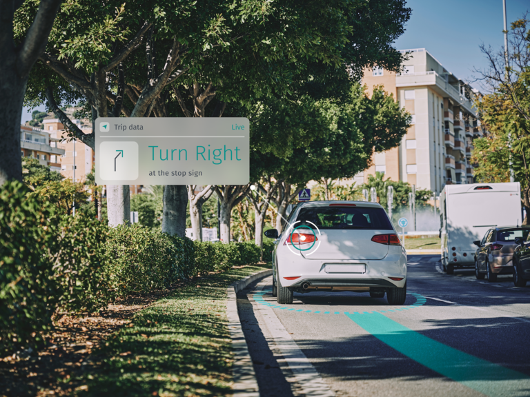 A car prepares to turn right at an upcoming stop sign.