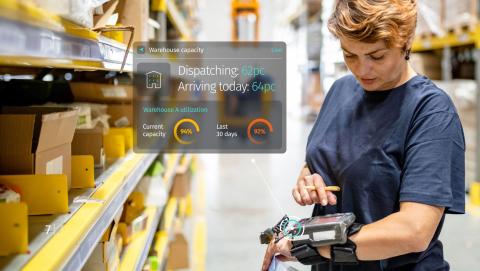 woman checking tracker in warehouse