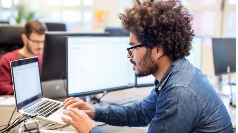 Man typing on a laptop