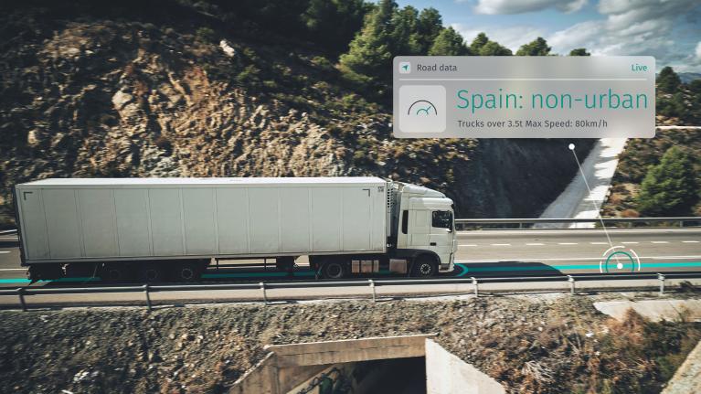 A fleet truck driving and using fleet routing, dynamic routing and location technology to get speed limit data alerts.