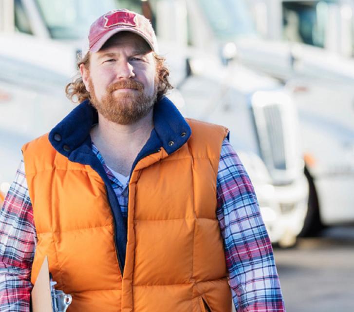 Man in front of trucks