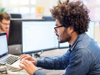 man on computer in office