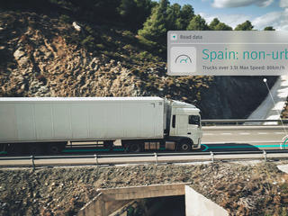 A fleet truck driving and using fleet routing, dynamic routing and location technology to get speed limit data alerts.