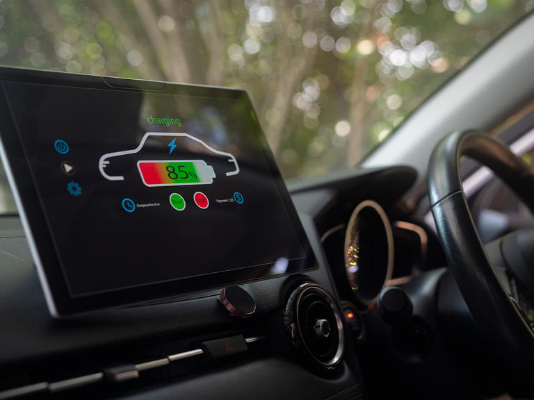 A dashboard view of an electric vehicle being charged.