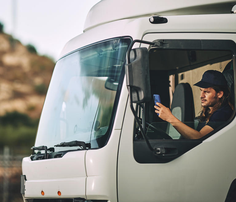 Professional driver in truck using navigation and safety information