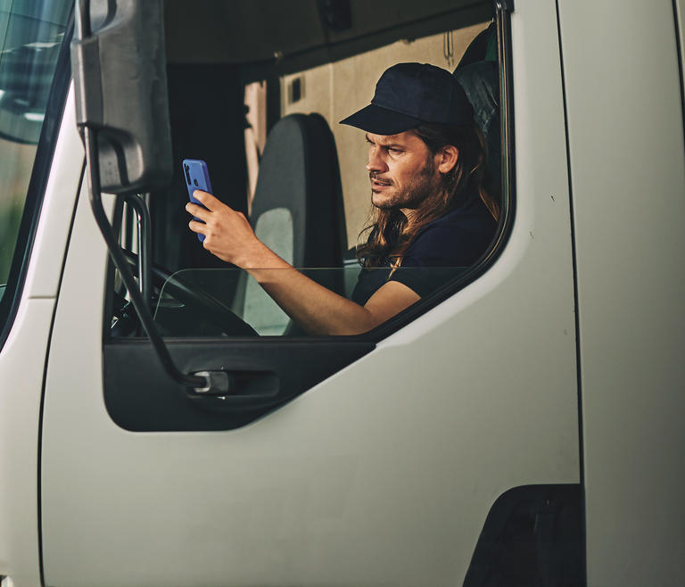 Professional driver in truck using navigation and safety information